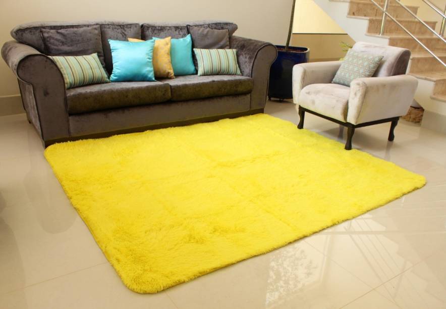 Tapete Peludo Amarelo, da DS Decor, de poliéster, 2,40 x 2 m. <a href="https://www.shoptime.com.br/produto/92111366/tapete-carpete-2-00x2-40m-peludo-felpudo-pelo-alto-macio-sala-quarto-amarelo-ds-decor?pfm_carac=tapete%20sala%20pelo%20alto&pfm_index=0&pfm_page=search&pfm_pos=grid&pfm_type=search_page%20" target="_blank" rel="noopener">Shoptime</a>, R$ 299,90