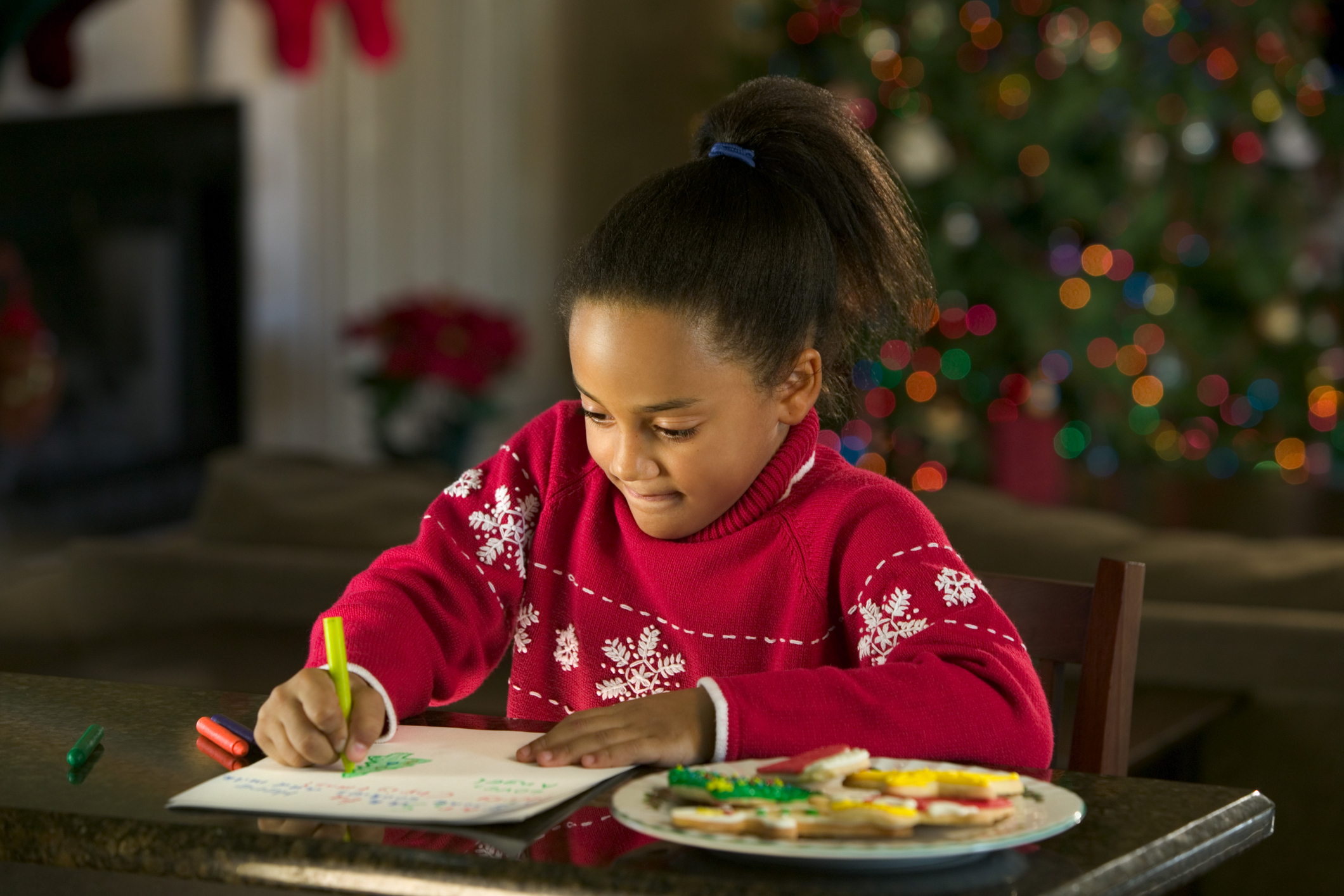 Girl writing Christmas wish list