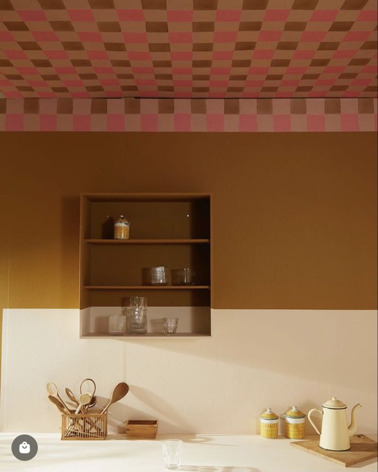 Teto pintado com xadrez em rosa e terracota sobre parede em mostarda