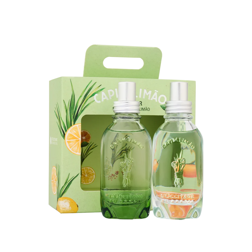 Duas garrafas de vidro transparente com l&iacute;quido verde claro, tampas prateadas e r&oacute;tulos Capim Lim&atilde;o, dentro de uma caixa verde com ilustra&ccedil;&otilde;es de capim-lim&atilde;o e fatias de lim&atilde;o